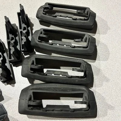 Set of black plastic car parts on a light gray background
