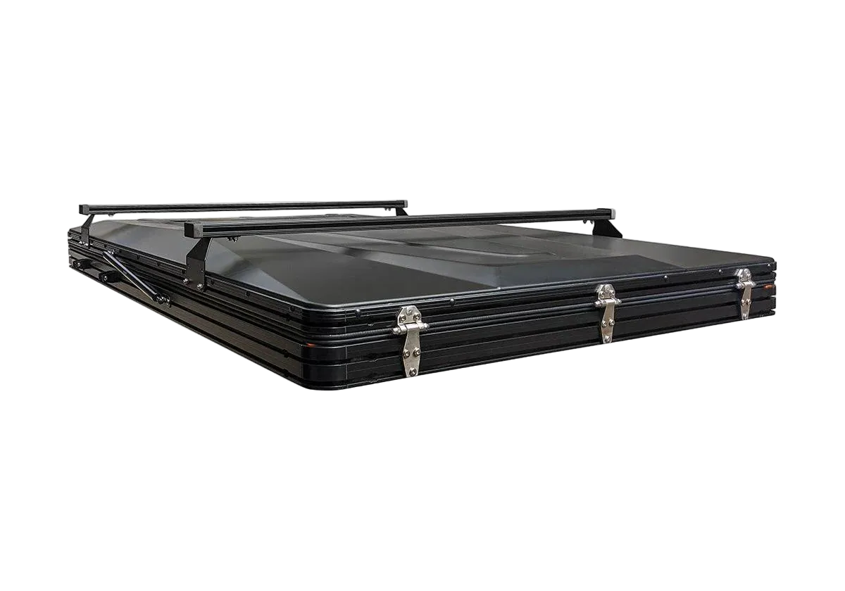 A black hard-shell roof rack carrying case with latches and a top handle, shown on a plain white background.