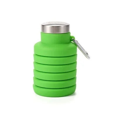 Green collapsible silicone water bottle partially collapsed with cap removed and placed nearby