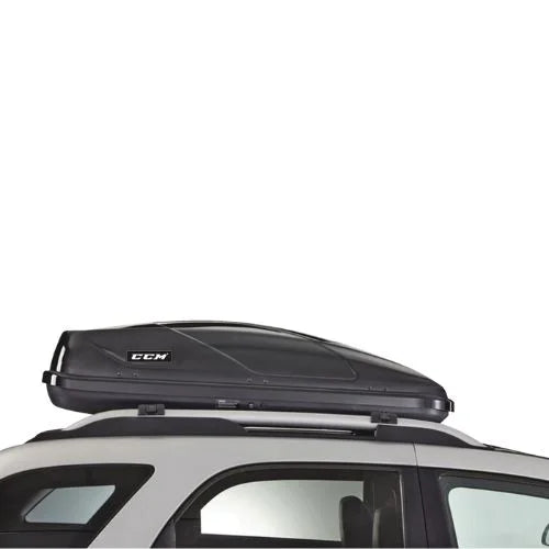 Side view of CCM Cargo Box mounted on white vehicle roof rack, highlighting aerodynamic shape