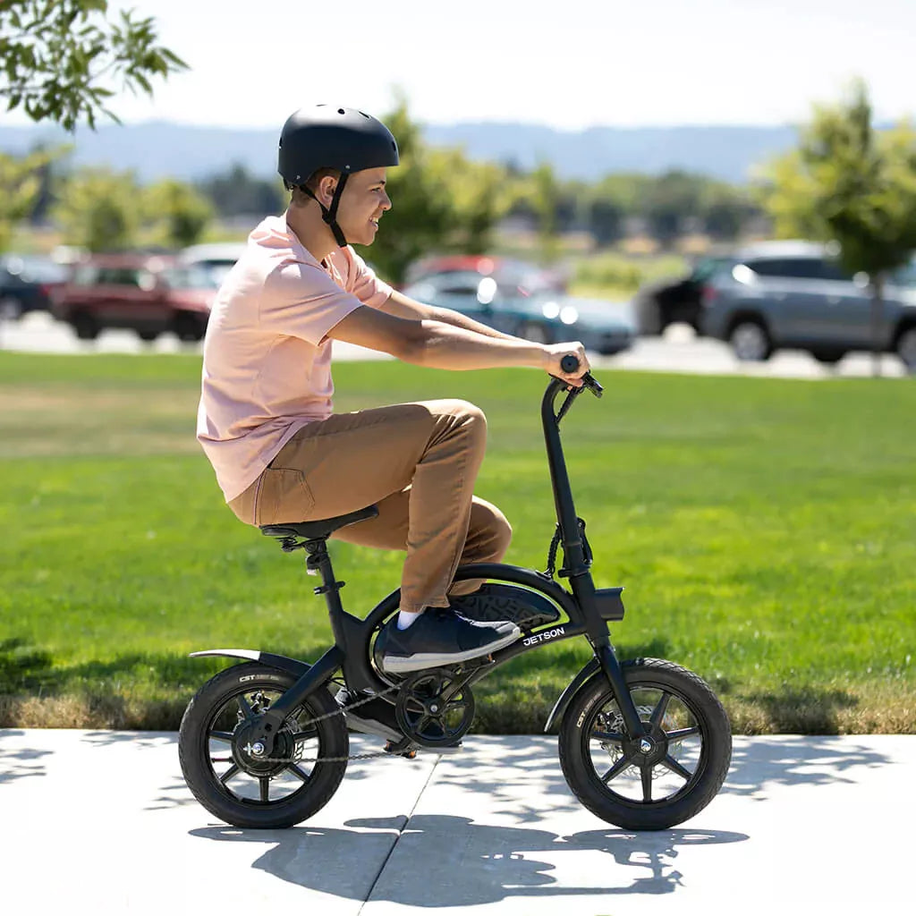 Person riding Jetson Bolt Pro E-Bike walk way next to grass