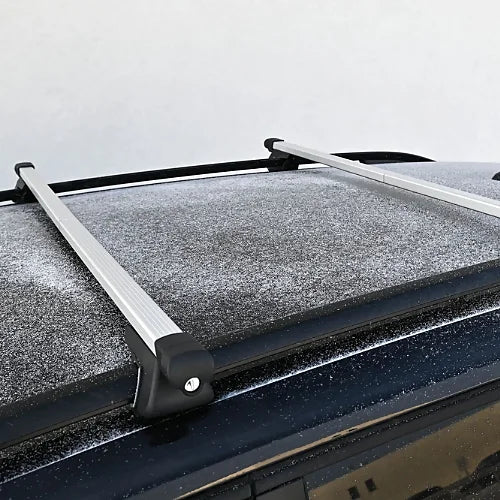 Adjustable rooftop crossbars installed on snow-covered SUV roof