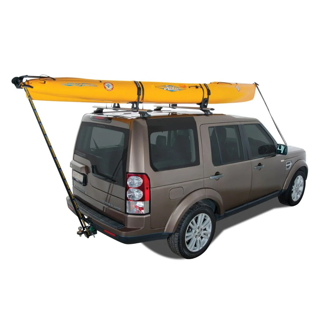 Vehicle with a yellow kayak loaded onto the Rhino-Rack Nautic 571 rear-loading carrier on the roof.