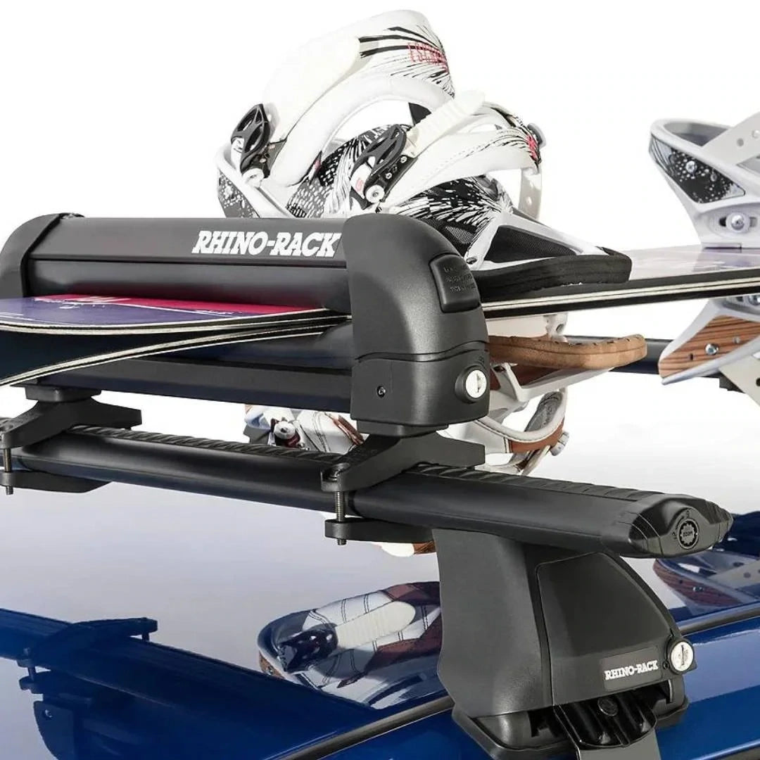 Close-up of skis secured inside the Rhino-Rack ski carrier mounted on a roof rack.