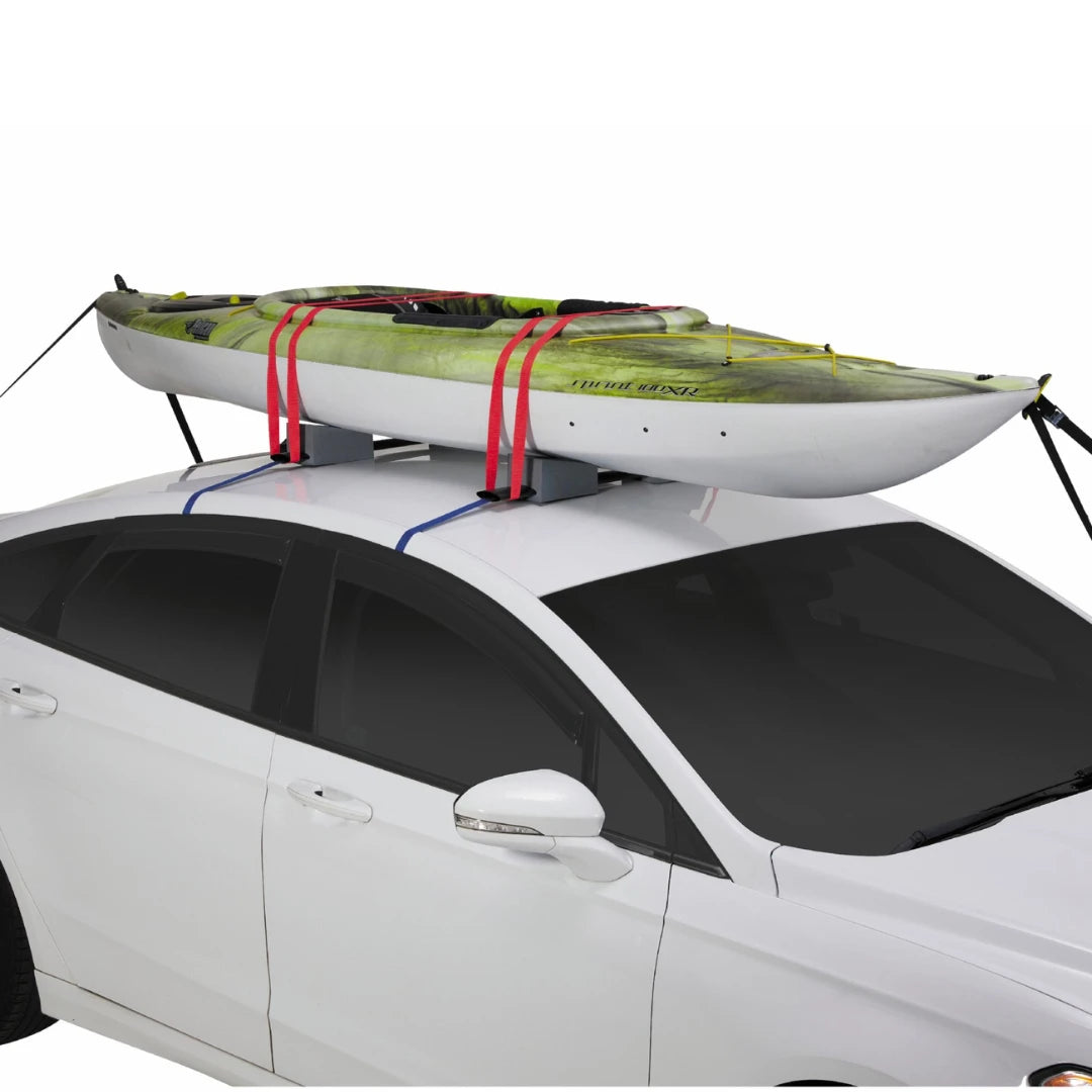 Kayak secured with SportRack foam blocks and red straps on the roof of a white car