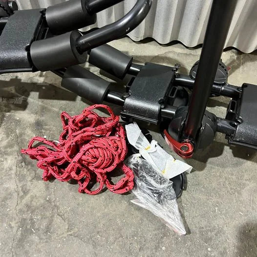 Swiss Cargo 3-in-1 Kayak Carrier folded flat for storage with red tie-down rope next to it.