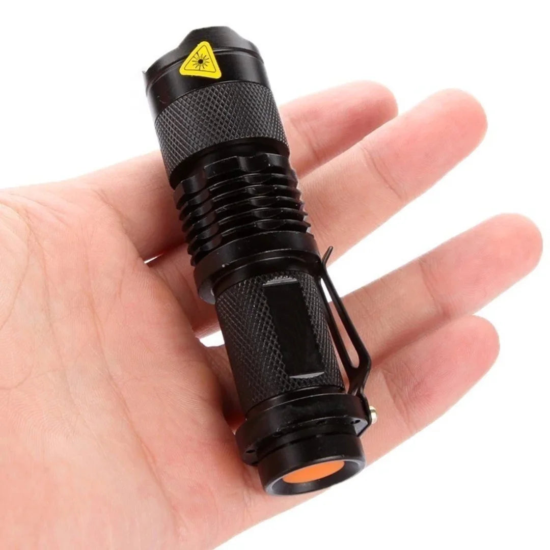 Person holding AO tactical flashlight in their hand for size reference