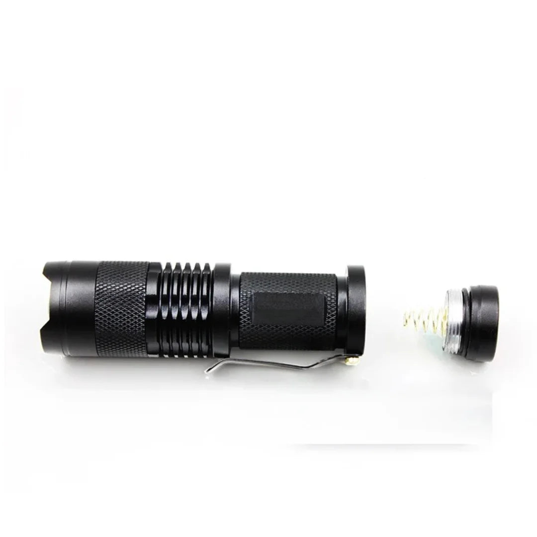 Disassembled AO flashlight showing battery compartment and internal parts
