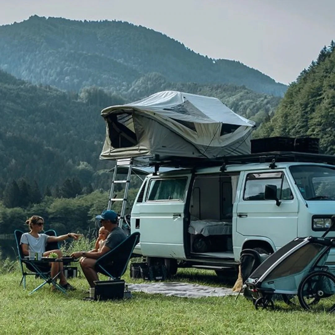 Family camping scene with rooftop tent and Caprock Platform on SUV, demonstrating outdoor use.