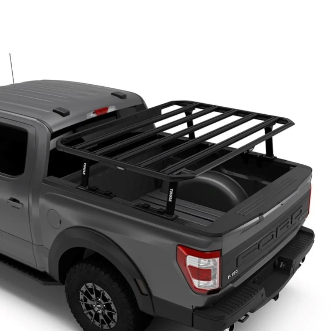 Thule Caprock Platform mounted over the bed of a grey pickup truck.