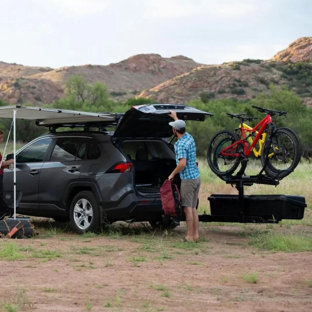 attached to car parked under a tarp in mountain environment