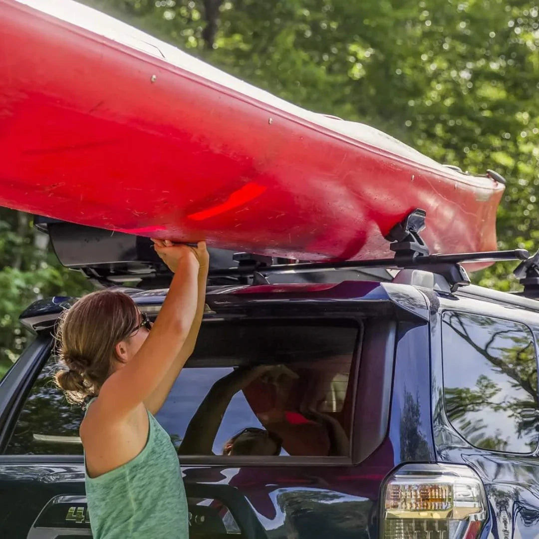 Yakima SweetRoll Kayak Saddles lifted on car by women
