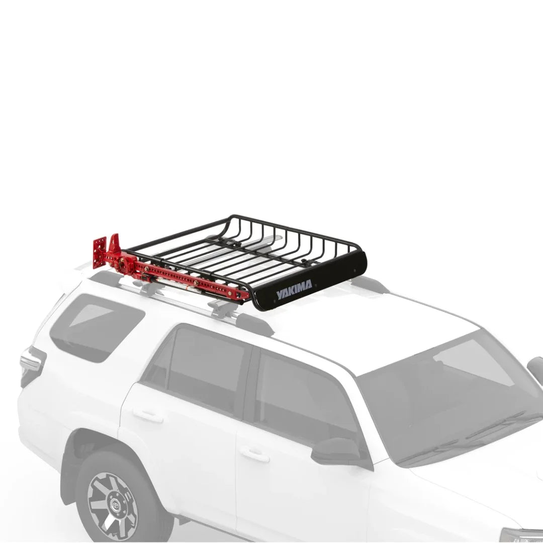 Yakima basket mounted on SUV roof rack, shown with red cargo straps.
