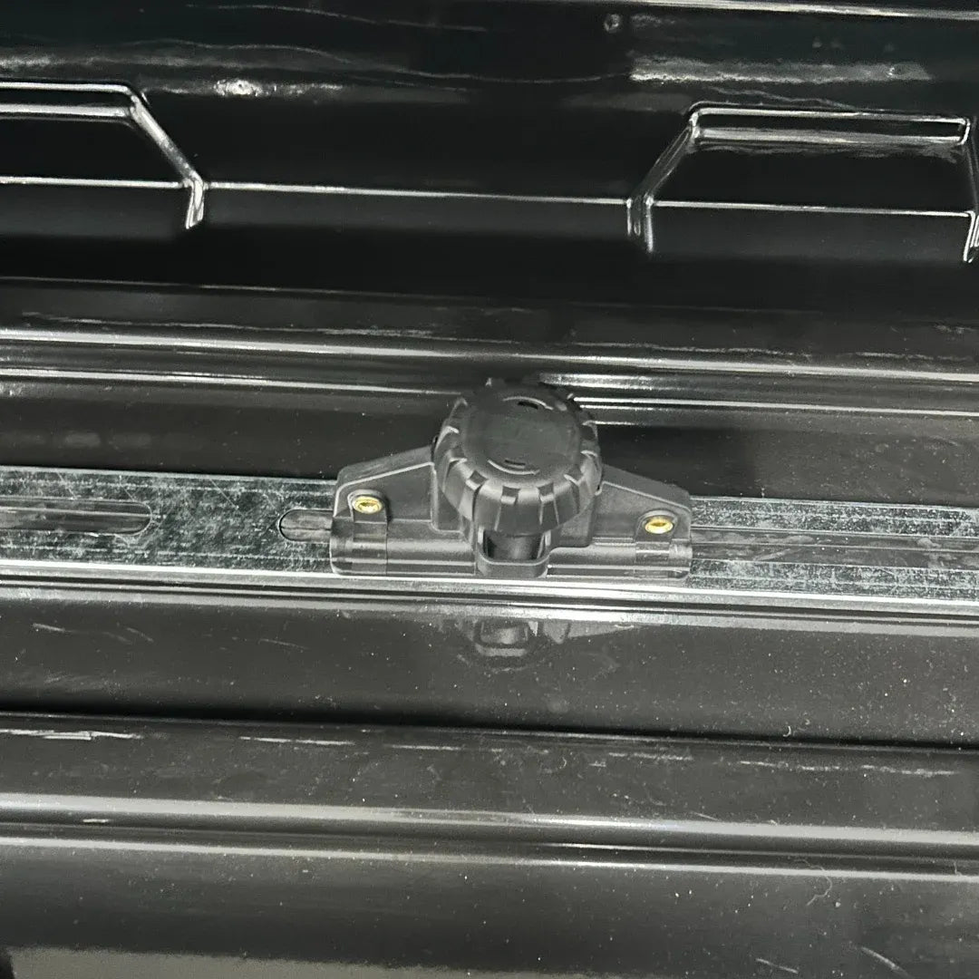 Close-up of twist-style U-Mount clamp system inside rugged Alpine rooftop cargo box