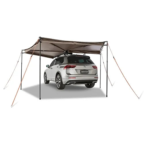 Rhino-Rack Batwing Compact Awning fully extended with guy ropes over SUV
