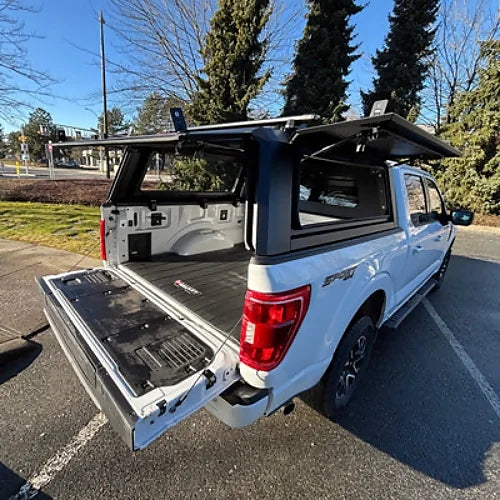 Stainless steel overland canopy for Dodge Ram 1500 2009–2025 & Ram Classic 2019–2024 5.7' bed, gullwing side doors open for easy access.