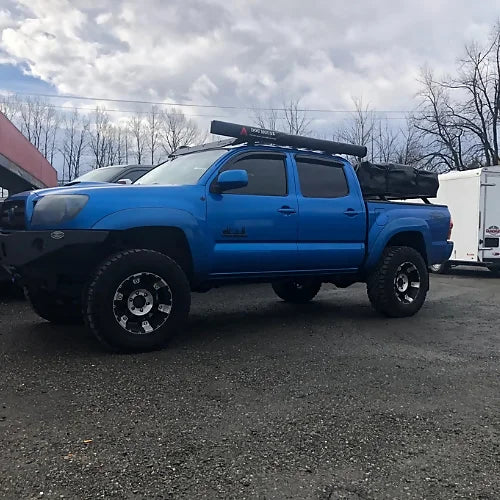 Dog House truck awning closed on roof rack for overland camping setup