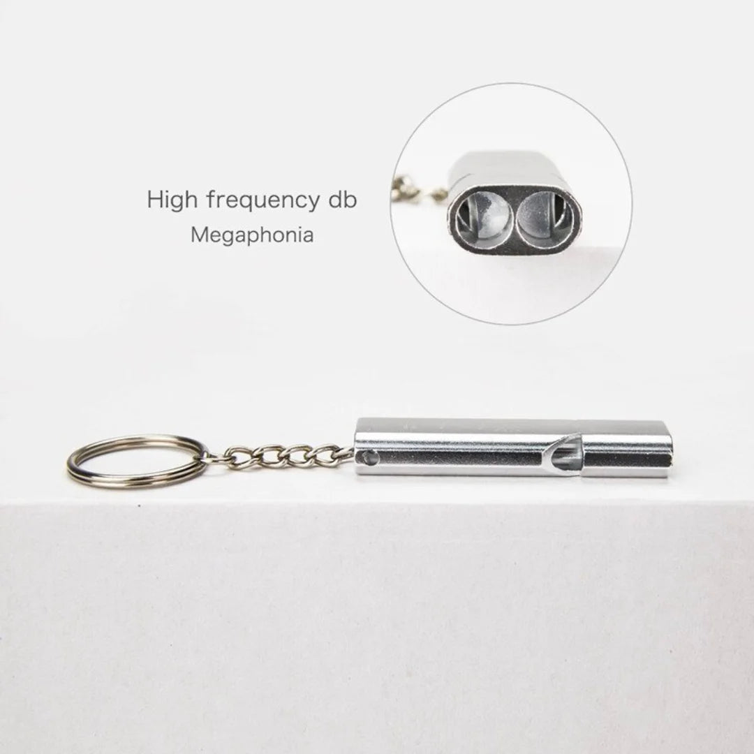 Close-up of AO whistle showing double tube design for high-frequency sound