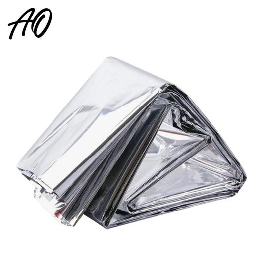 Hand holding compact folded emergency thermal blanket for size reference