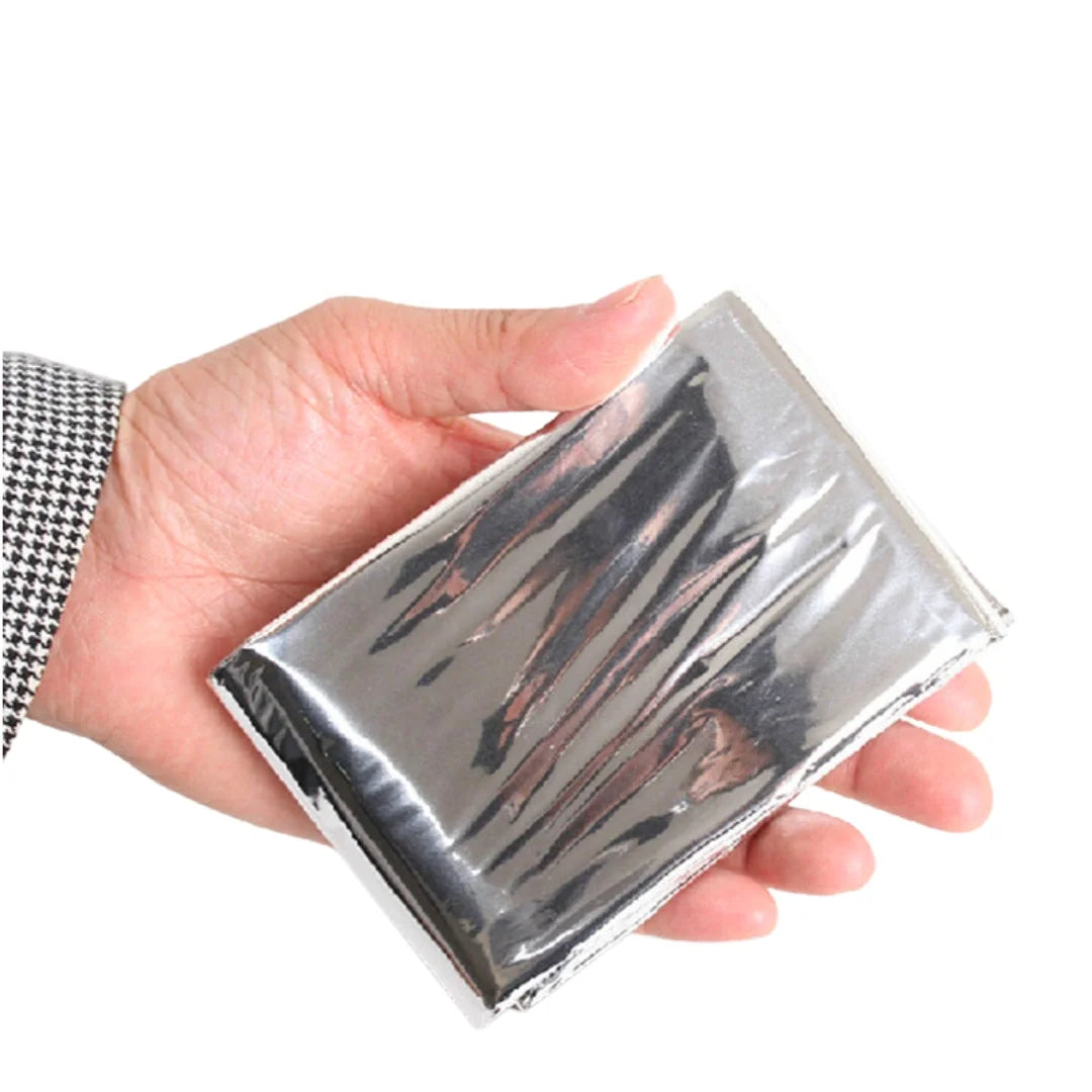 Folded emergency thermal blanket with Adventure Outdoors logo on a white background
