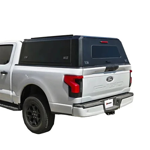 Rear side angle view of Ford F150 with stainless steel smart canopy installed, matte black finish