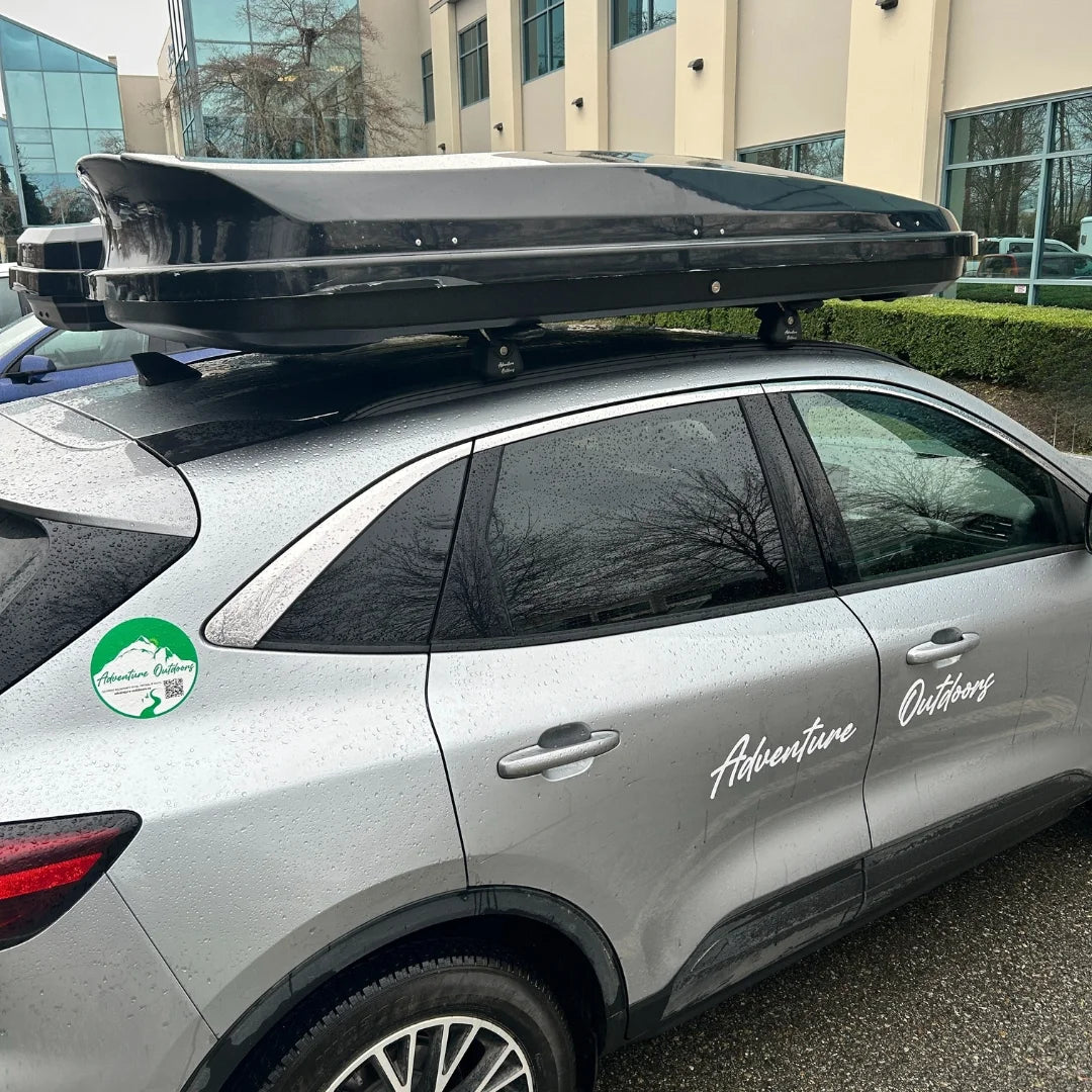 Large low profile rooftop alpine cargo box mounted on SUV for travel and outdoor gear storage