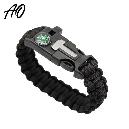 Black paracord survival bracelet with built-in compass, whistle, fire starter, and rope cutter.