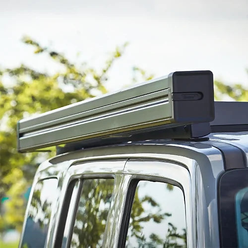 Closed ReTract AO Auto Retractable Awning mounted on roof rack, streamlined aluminum cassette for SUV or off-road vehicles