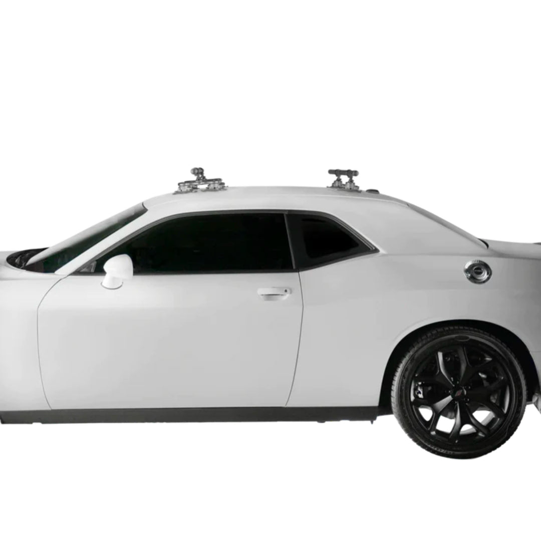 SeaSucker Monkey Bars installed on the roof of a sleek black coupe.
