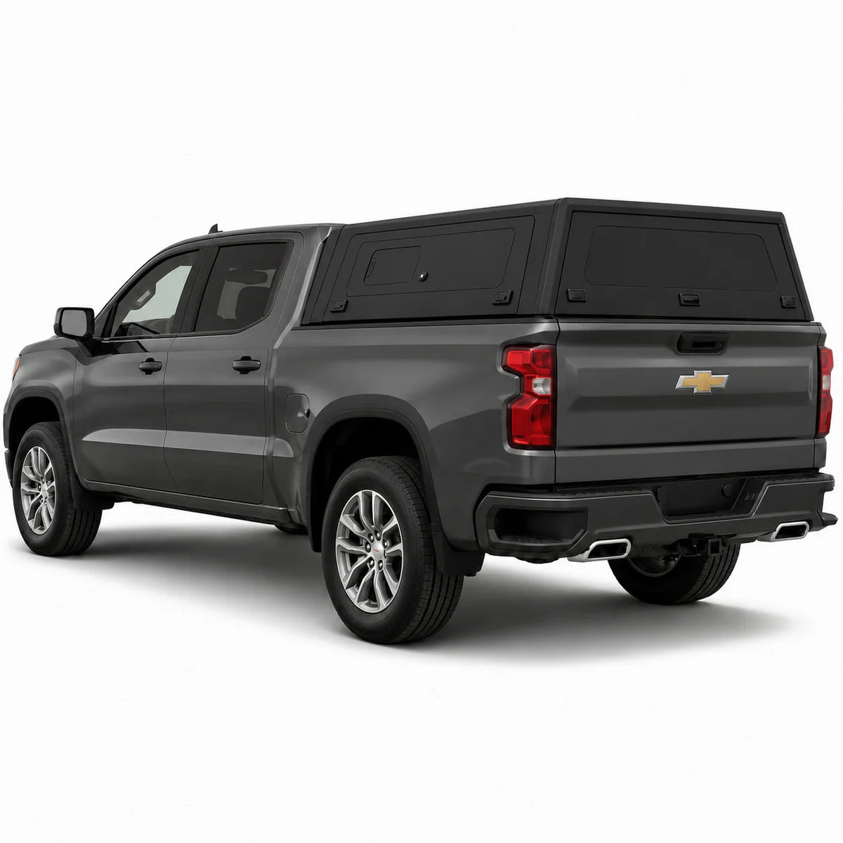 A dark gray Chevrolet pickup truck with a black hardtop canopy over the bed, shown from a rear three-quarter angle on a white studio background.
