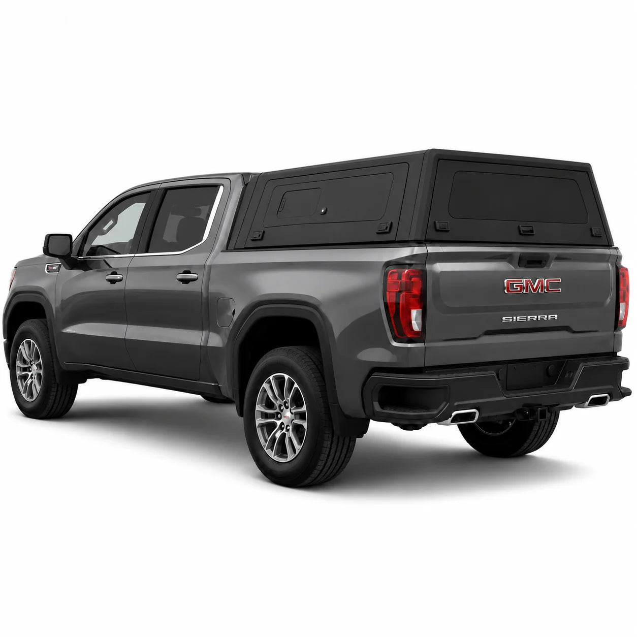 A dark gray GMC Sierra pickup truck with a black hardtop canopy over the bed, shown from a rear three-quarter angle on a white background.