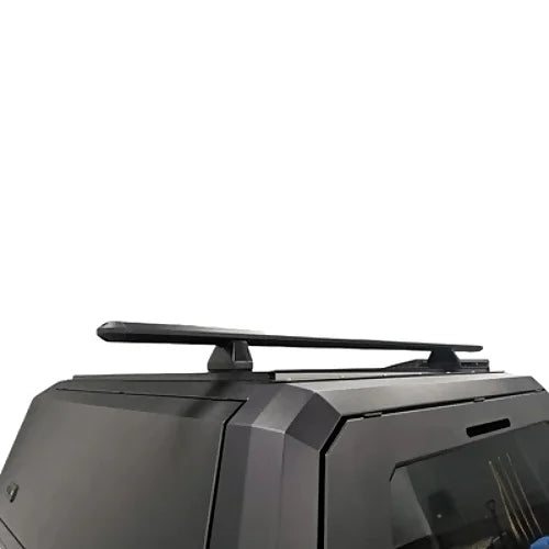 Side profile of roof rack on black pickup canopy, showing aerodynamic rail system