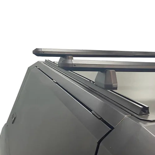 Side close-up of stainless steel canopy roof rack mounting and support rails on pickup truck