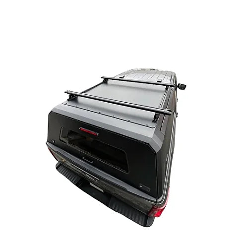 Top view of black heavy-duty stainless steel roof rack mounted on a pickup canopy