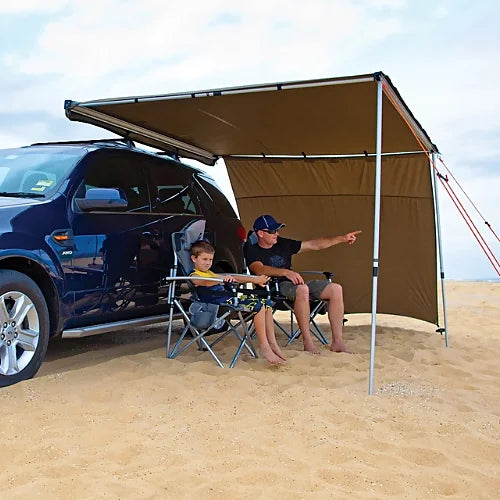 Father and child relaxing under Sunseeker Side Wall setup at the beach