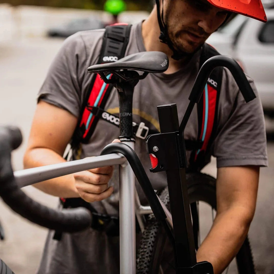 Close-up of a person securing a bike to the Swagman XTC ratchet arm.