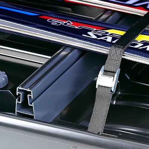 Thule ski carrier adapter close-up view inside roof box with ski strap secured