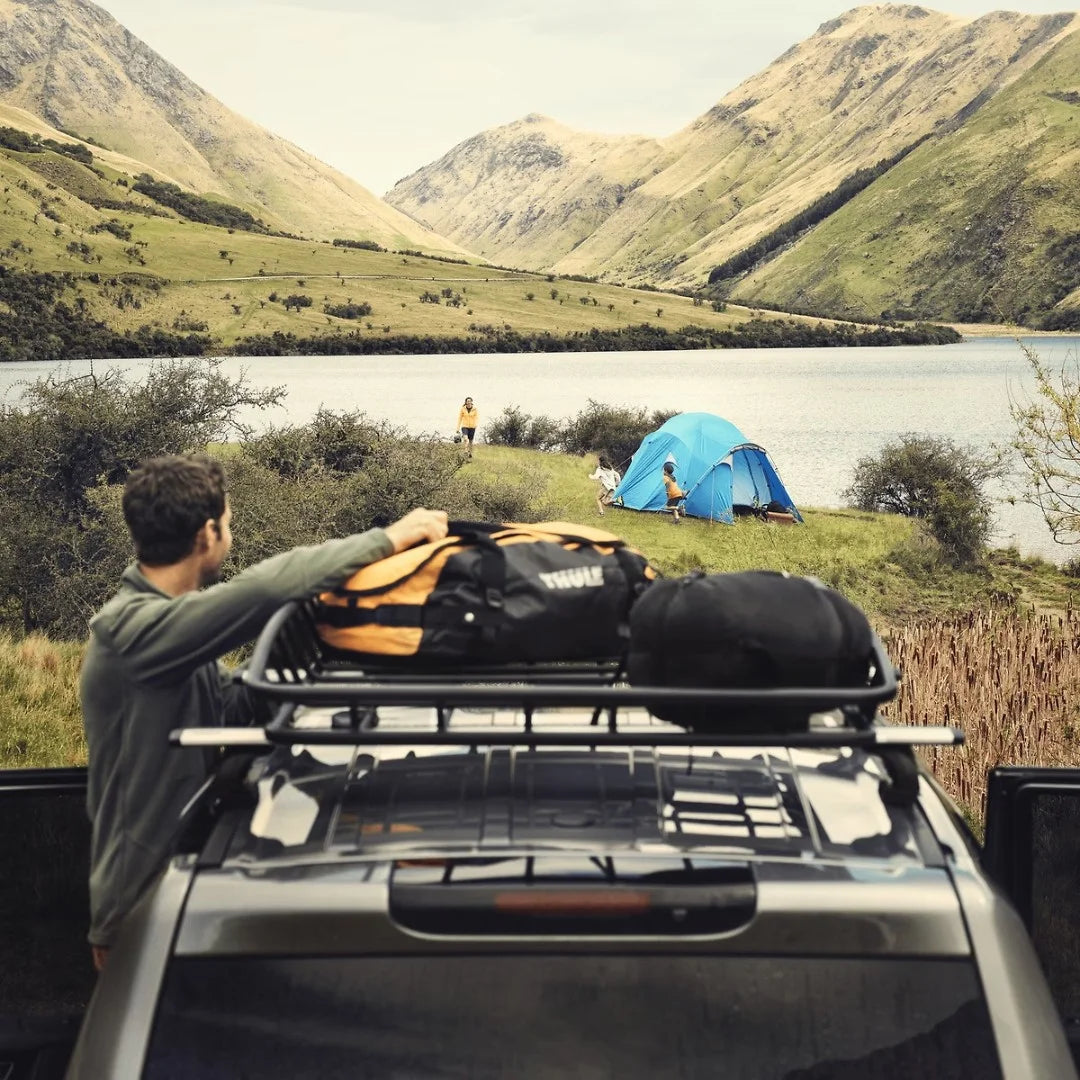 Thule Canyon XT Cargo Basket
 in beautiful scenery with man loading bags onto it