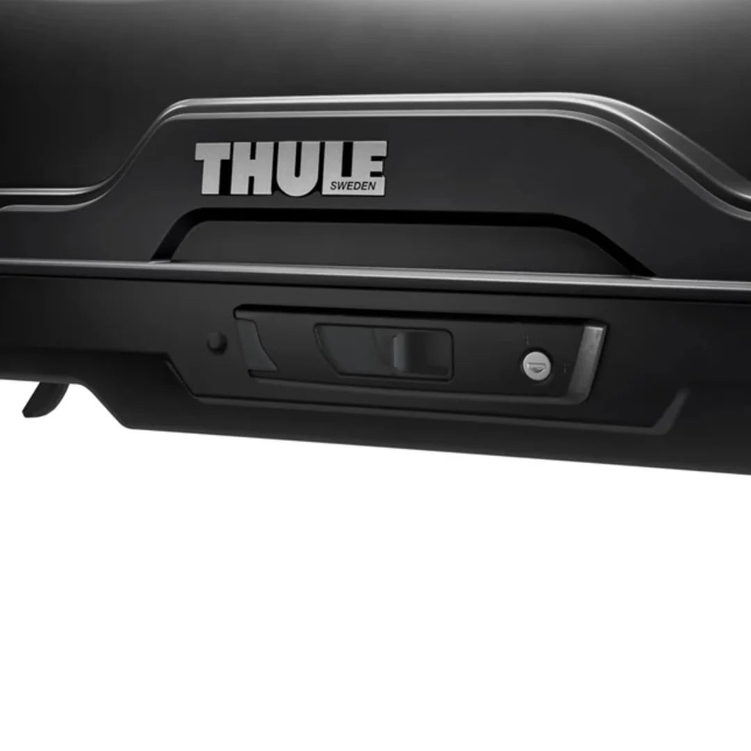 Close-up of the Thule SlideLock locking system with the Thule logo and lock indicator.