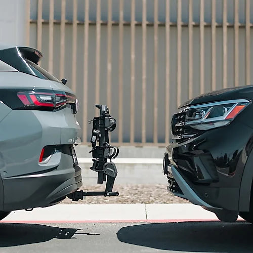 Thule OutPace Hitch Bike Rack shown compactly mounted between two parked vehicles