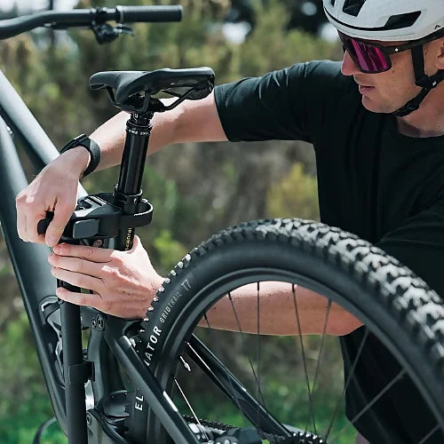 Close-up of cyclist adjusting frame clamp on Thule OutPace Hitch Bike Rack