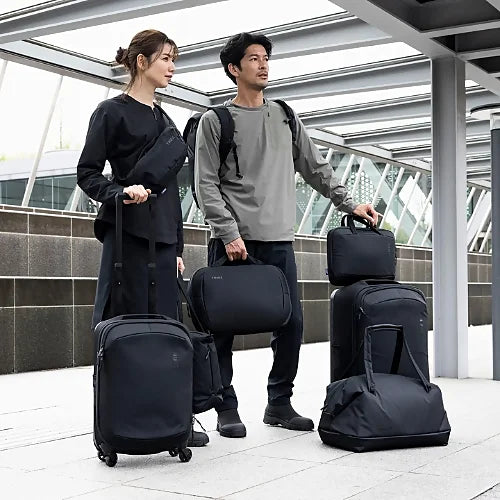 Travelers using Thule Subterra 2 carry-on spinners and bags in real-world travel setting