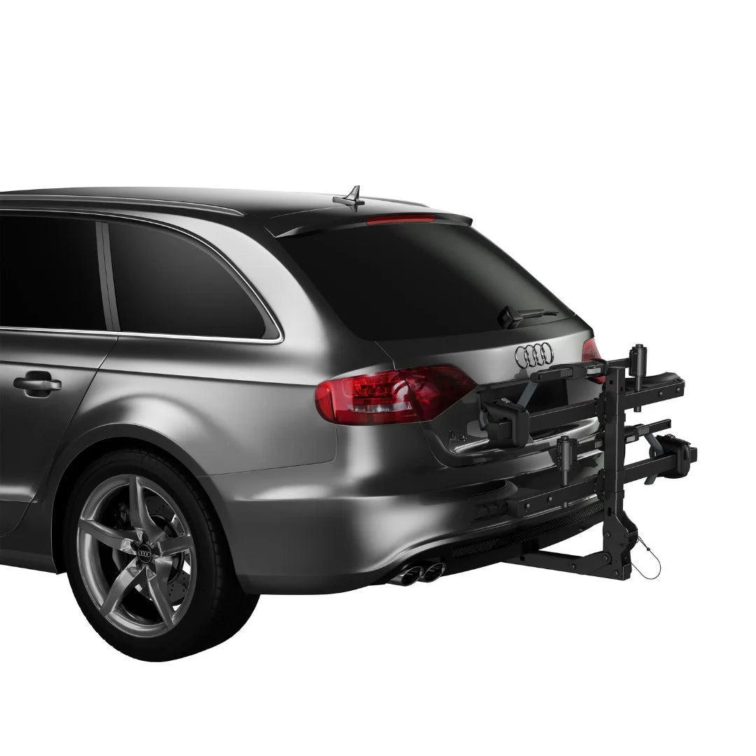 Rear view of the Thule T2 Classic rack folded up against the back of the SUV when not in use.