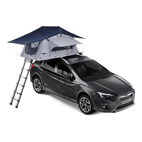 Thule Tepui Ayer 2 rooftop tent with blue rainfly fully deployed on top of a dark crossover