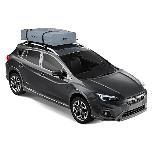 Thule Tepui Ayer 2 tent folded in closed travel mode on top of a dark gray crossover SUV