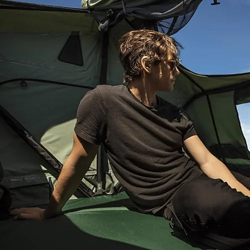Interior of Thule Tepui Ayer 2 rooftop tent with camper sitting inside looking out on a sunny day
