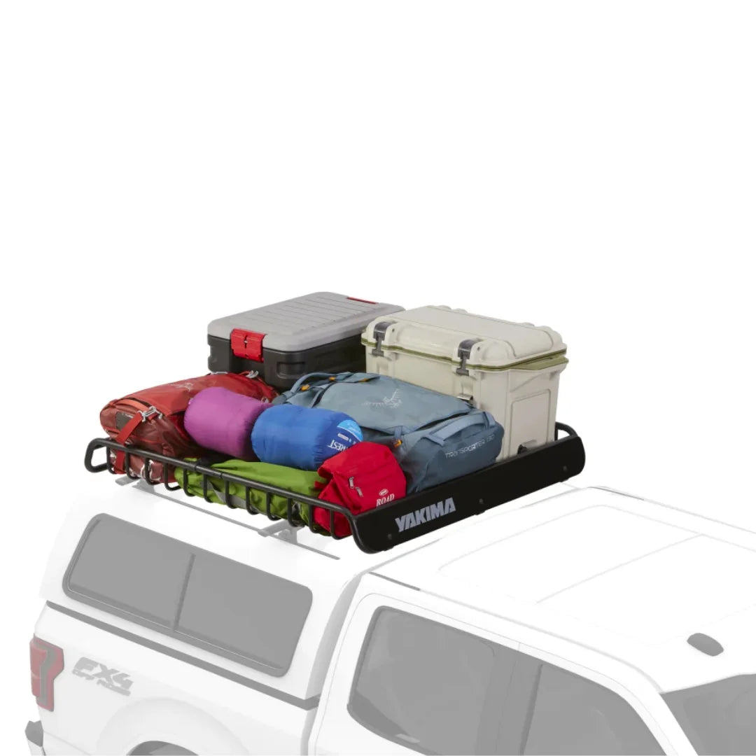 White SUV with Yakima basket loaded with coolers and duffel bags.