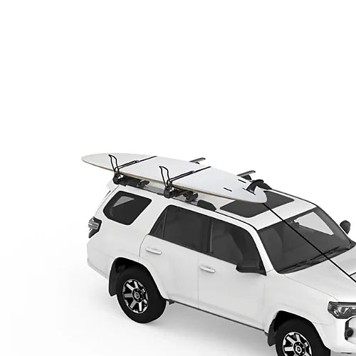 Yakima ShowDown carrying surfboards and paddleboards secured on SUV roof rack.