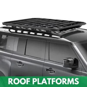 Black roof platform rack mounted on SUV for carrying cargo, rooftop tents, or gear – compatible with Thule, Rhino-Rack, and AO overland systems