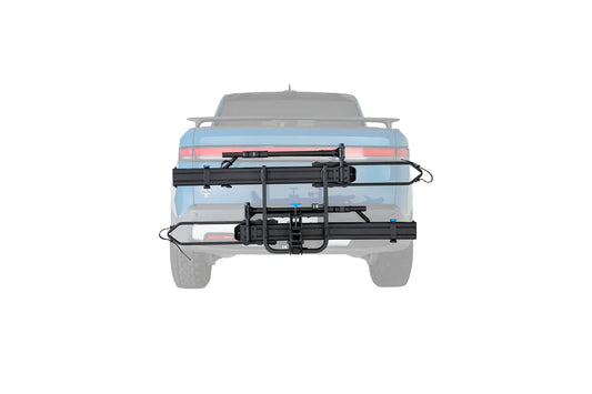 Bicycle rack attached to the back of a vehicle on a white background